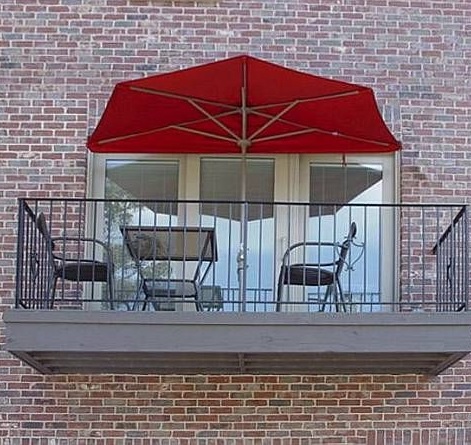 half parasol for balcony with red canopy and chairs