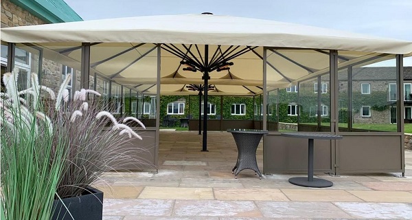 giant parasol in hospitality with side screens 